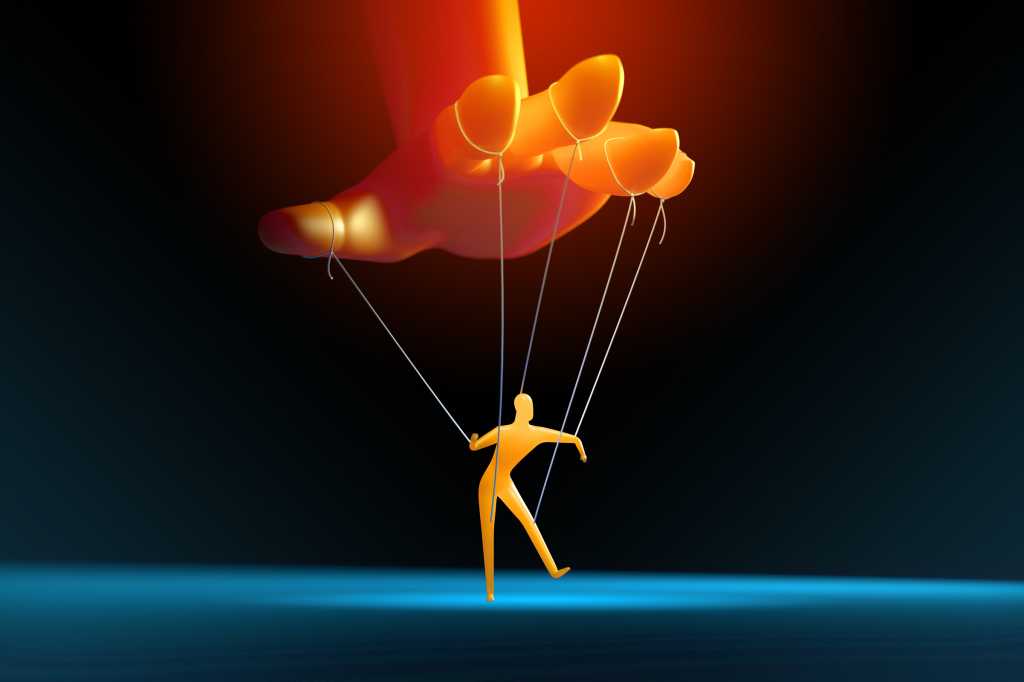A hand controls a small marionette. [control / manipulation / social engineering]