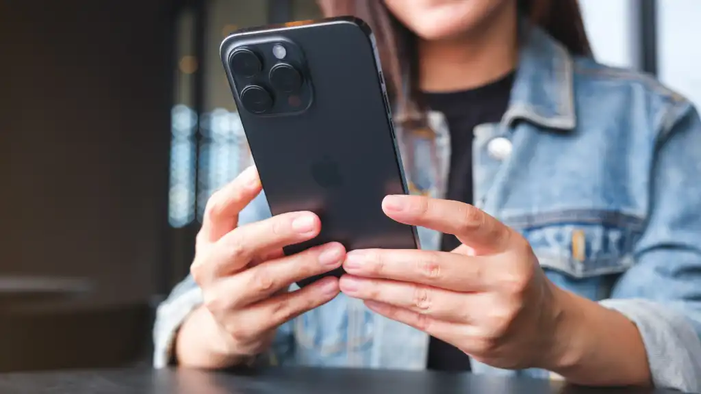 Aug 5th 2024 : A woman holding and using Iphone 15 Pro Max smart phone, Chiang mai Thailand