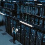 3D Computer Graphics: Data Center Female Chief Technology Officer Using Laptop Standing In Warehouse, Activates Servers, Information Digitalization Starts. SAAS, Cloud Computing, Online Service