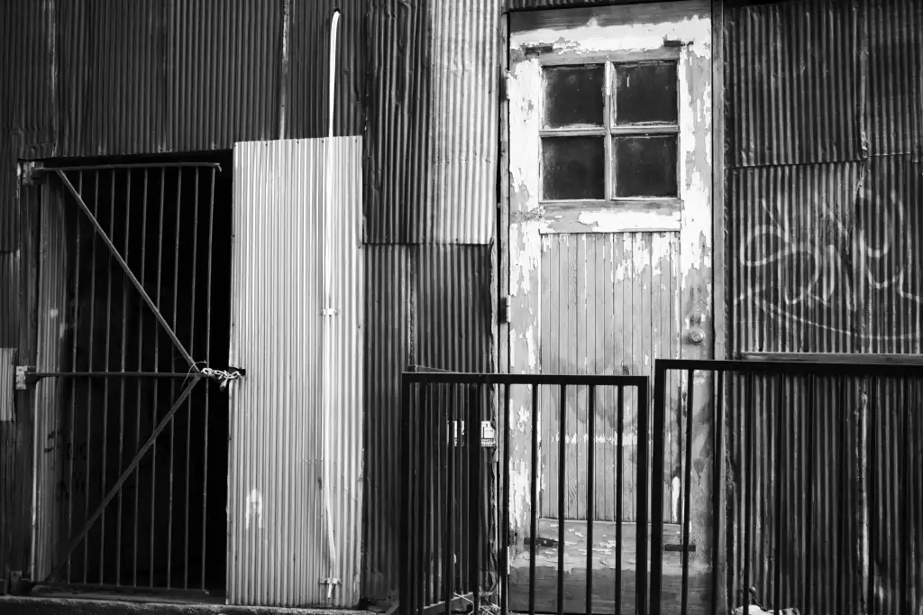 Black and white photo of a back door on an industrial building