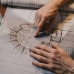 Close up on mans hand with architecture drawing
