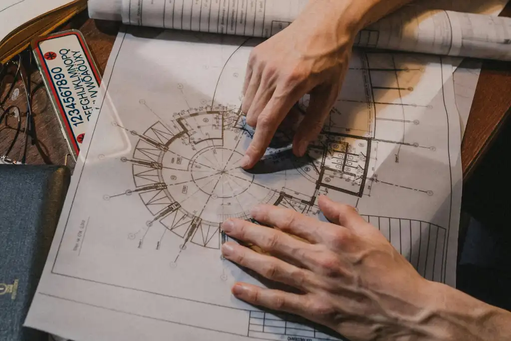 Close up on mans hand with architecture drawing