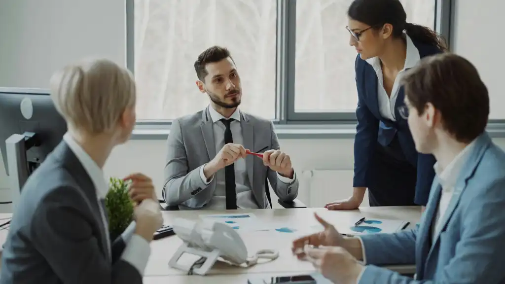 Business colleagues discussing, debating around a conference table