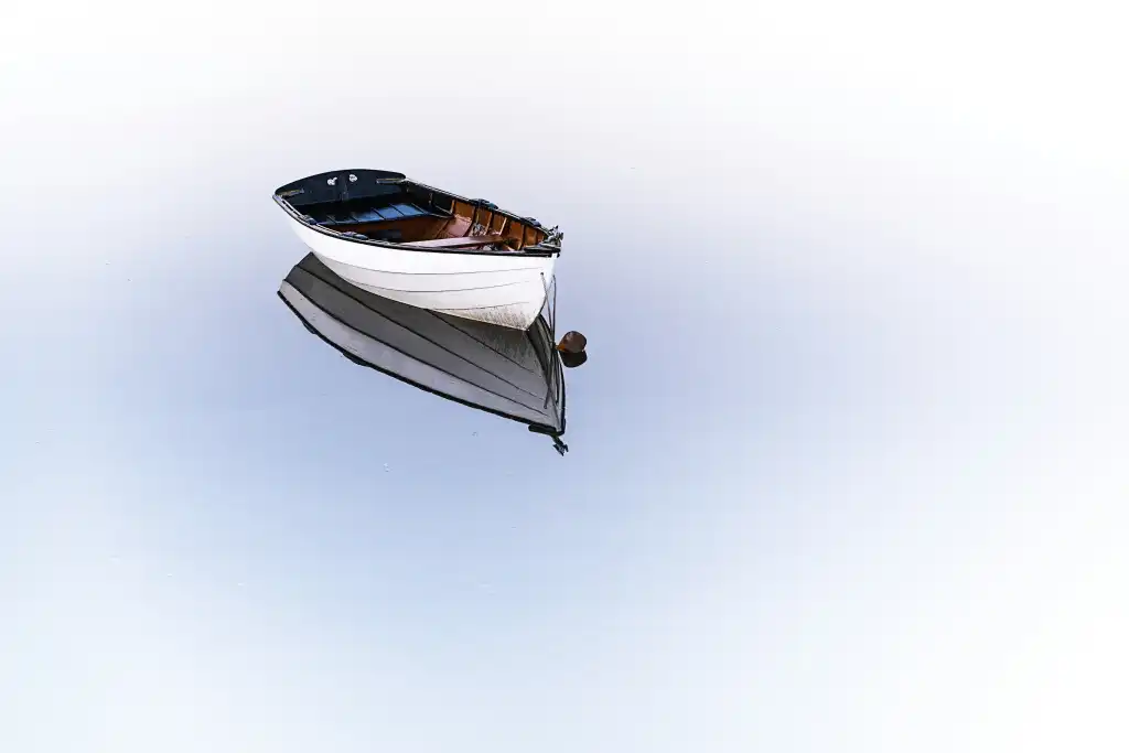White boat drifting on water
