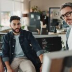 Programmer, teamwork and presentation with business people in office for website developer, coding and review. Mentor, collaboration and software engineer with group of employees in tech startup