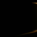 an open door in a dark room with light coming in