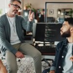 Programmer, mentor and presentation with business people in office for website developer, coding bootcamp and review. Planning, collaboration and software engineer with employees in tech startup