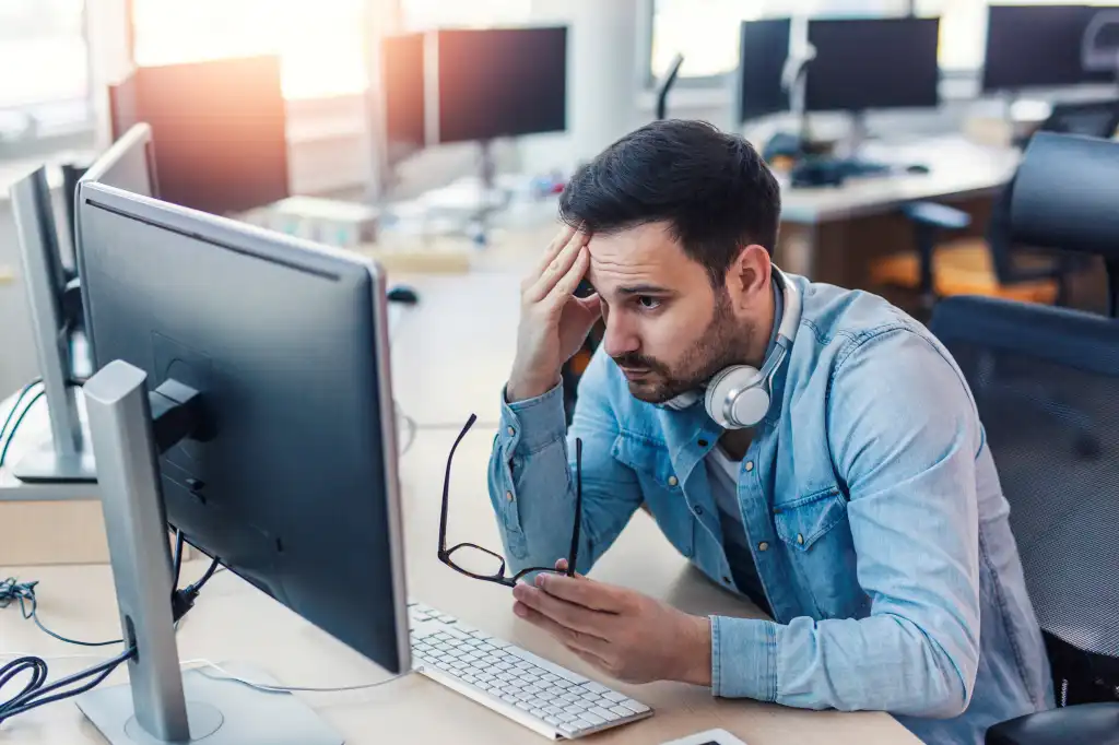 Handsome modern worried programmer working on project