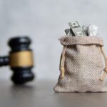 A picture of a bag of money and a judge