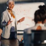 image of Mature female executive speaking at important meeting
