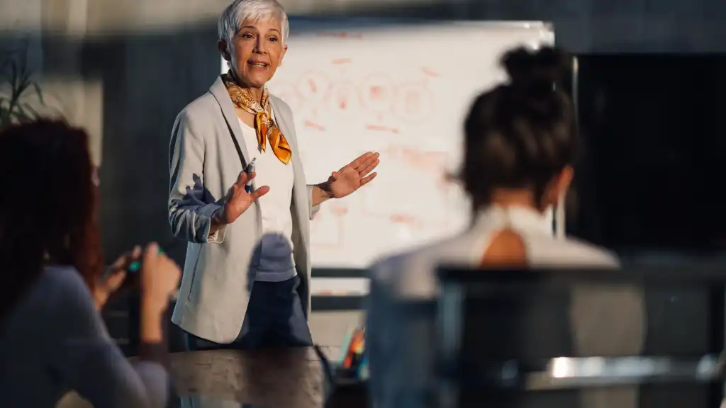 image of Mature female executive speaking at important meeting