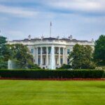 White House exterior with US flag and fountain