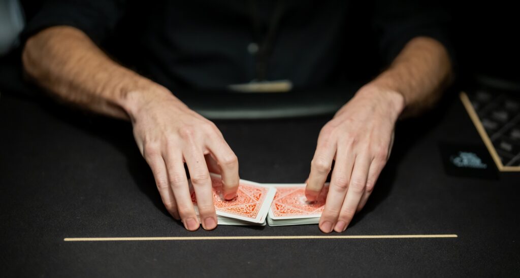 A picture of a poker dealer with the cards in his hand.