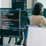 Group Adult Asia male, female freelance typing write prompt AI bot IT app smart program nomad, video game, terminal with coding language, user interface, designer, big data center on desktop computer.