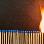 A series of matches are next to each other, which burn one after another.