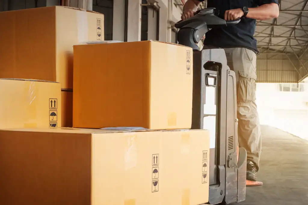 warehouse worker loading packages boxes for shipment at distribution center shipping dock
