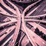 Aerial View of Curved Modern Architecture of Highways and Interchange urban sprawl abstract Drone angle red and Pink Effect
