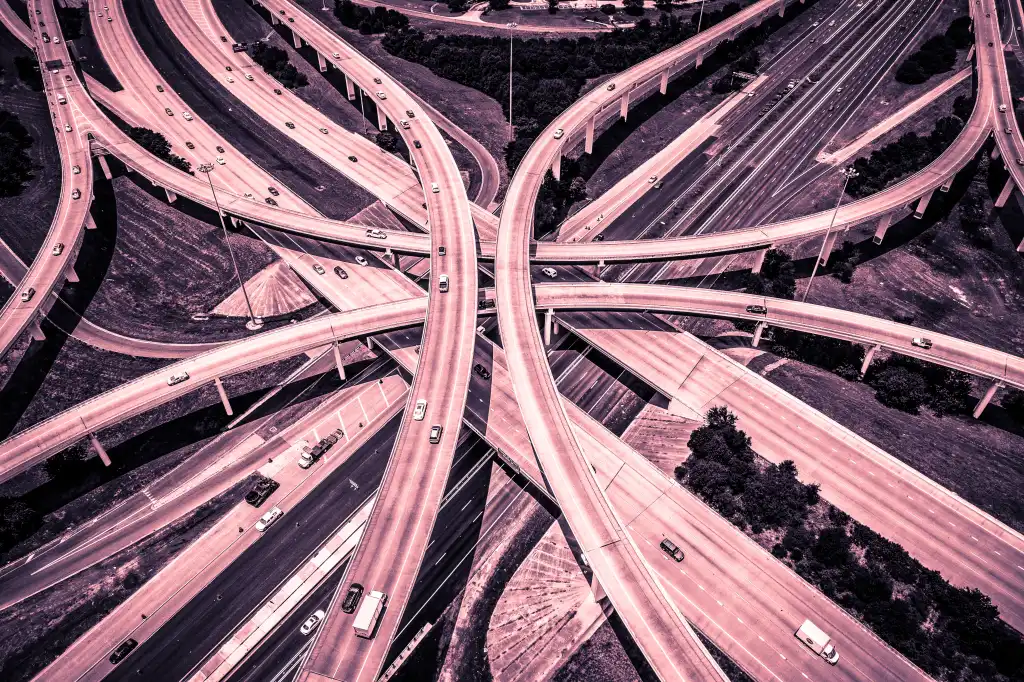 Aerial View of Curved Modern Architecture of Highways and Interchange urban sprawl abstract Drone angle red and Pink Effect