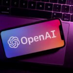 Azores, Portugal - 21.01.2023: SmartPhone on top of laptop keyboard with OpenAI Logo on the screen.