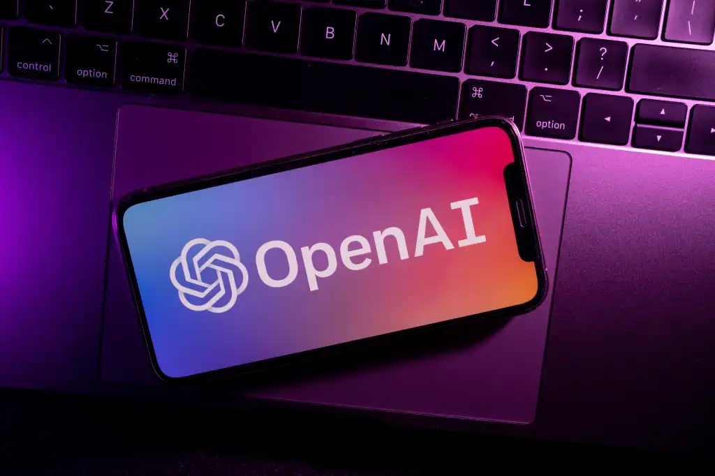 Azores, Portugal - 21.01.2023: SmartPhone on top of laptop keyboard with OpenAI Logo on the screen.