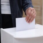 A picture of a woman casting a vote