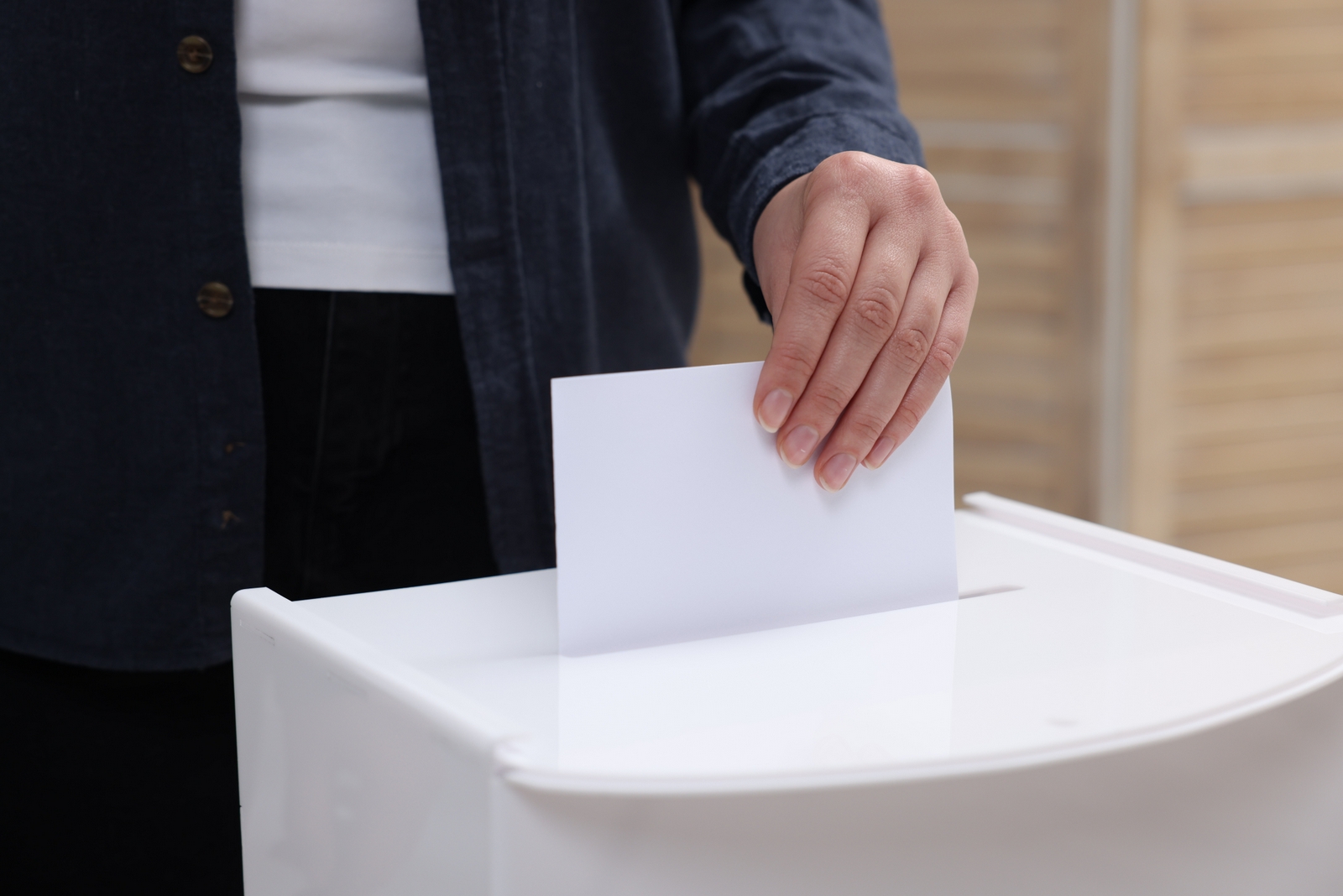 A picture of a woman casting a vote