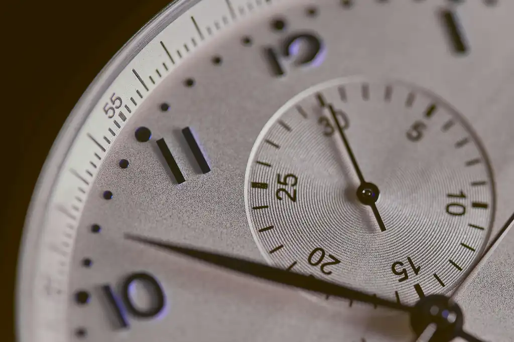 Closeup of a silver watch face.
