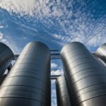 shutterstock 289153913 upward view of silver silos against a blue sky with clouds