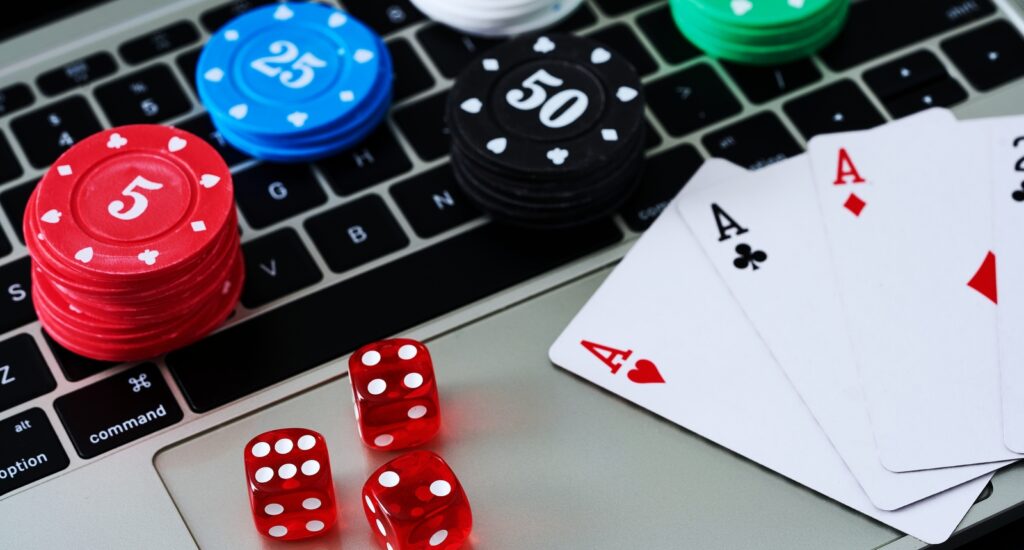 A picture of chips and cards and dice on a laptop