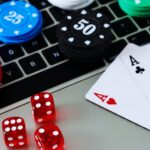 A picture of chips and cards and dice on a laptop
