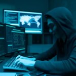 Sideview of asian male hacker use computer to commit a crime