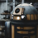 Blue and gold droid with a glowing light, from Disney