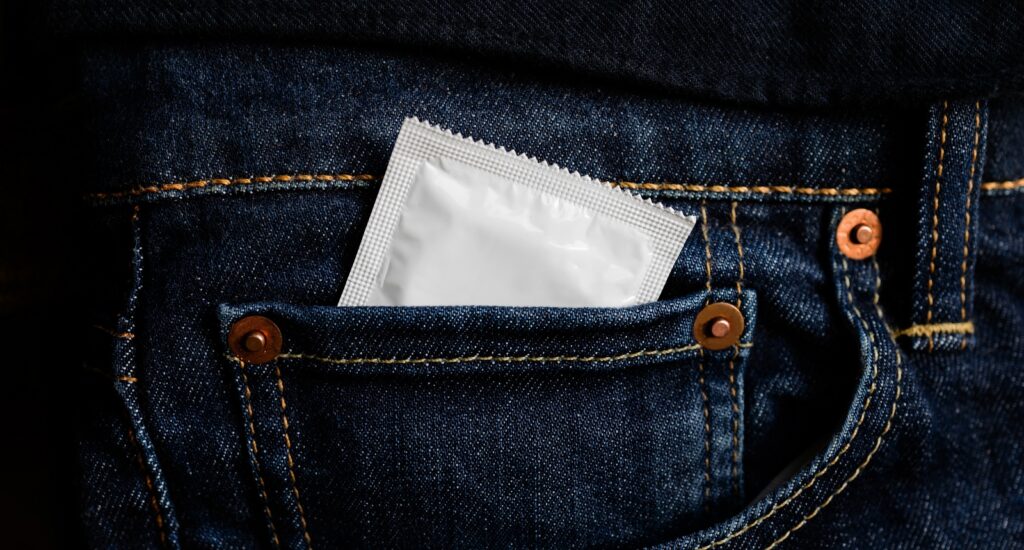 A picture of a condom in a jean pocket