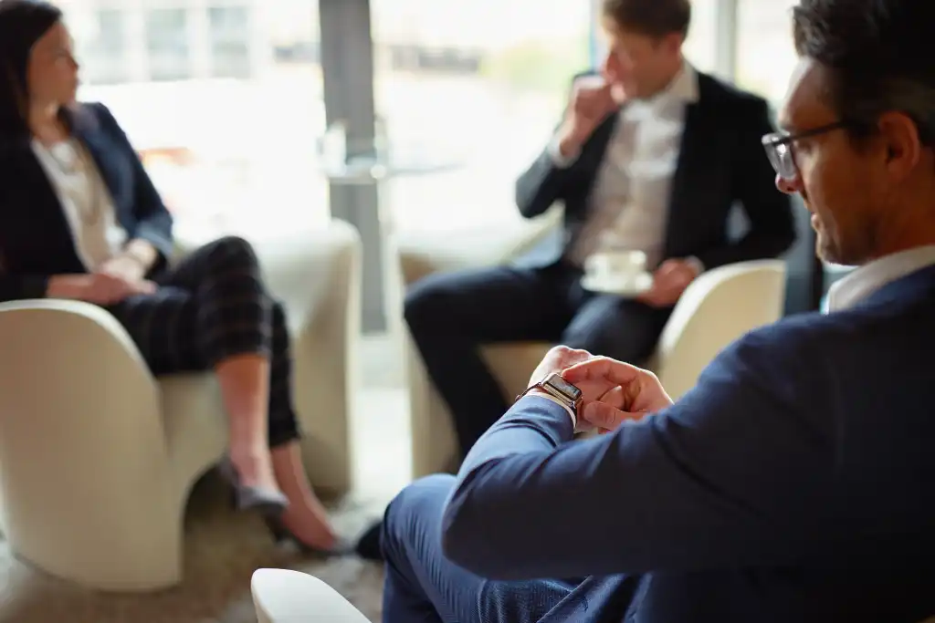 Check, watch or businessman in meeting, discussion or collaboration for teamwork or growth. Appointment, time management or financial manager in office planning for loan, feedback report or project
