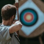 Man archery bow and arrow target