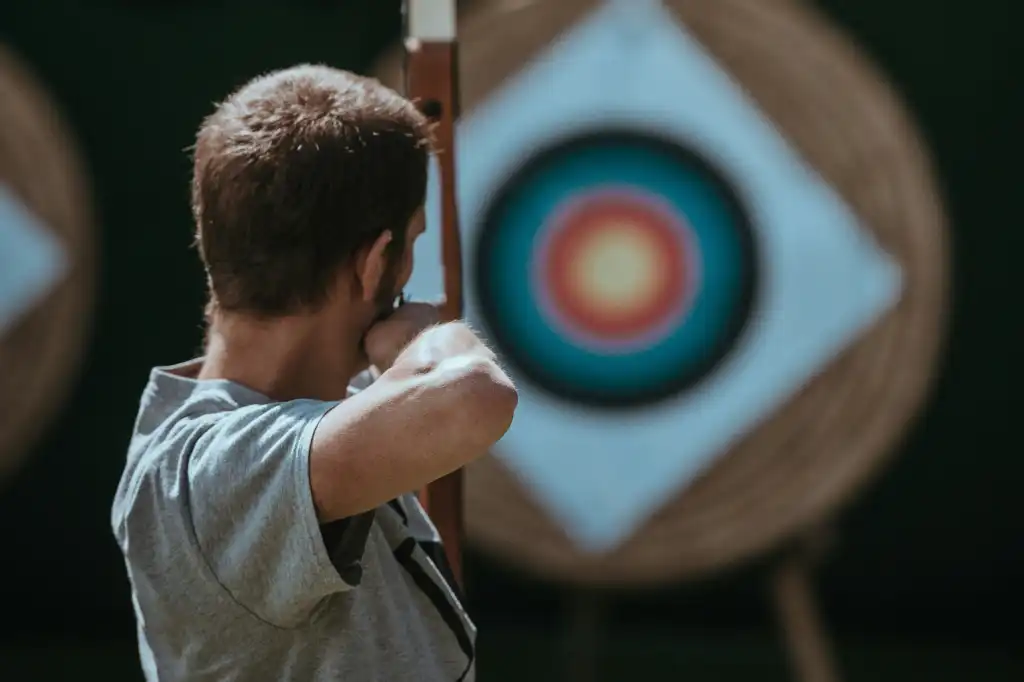 Man archery bow and arrow target
