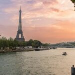 Eiffel Tower over the Seine river at sunset.