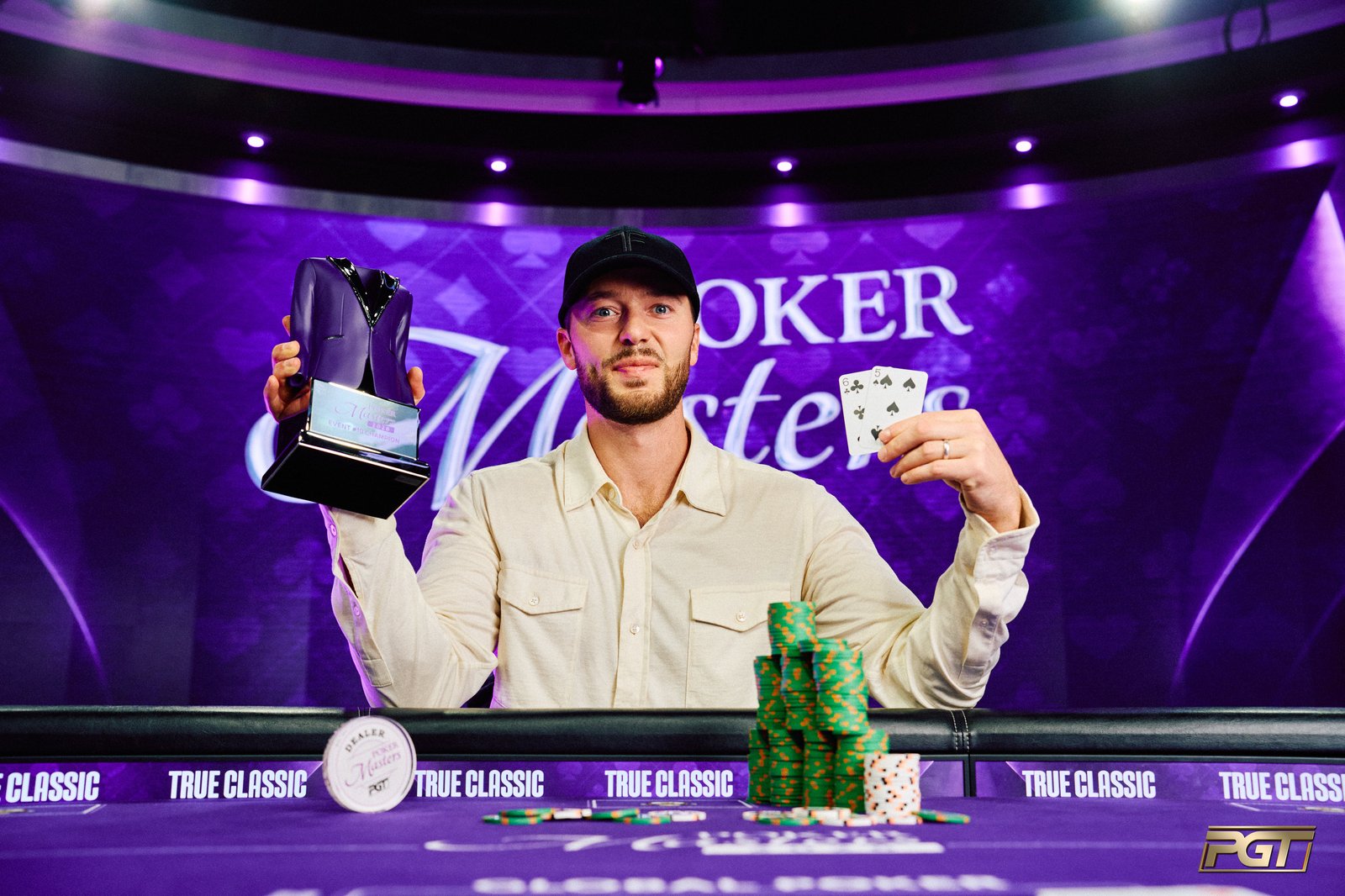Sean Winter holds the Poker Masters event no. 10 trophy at the PokerGO Studio